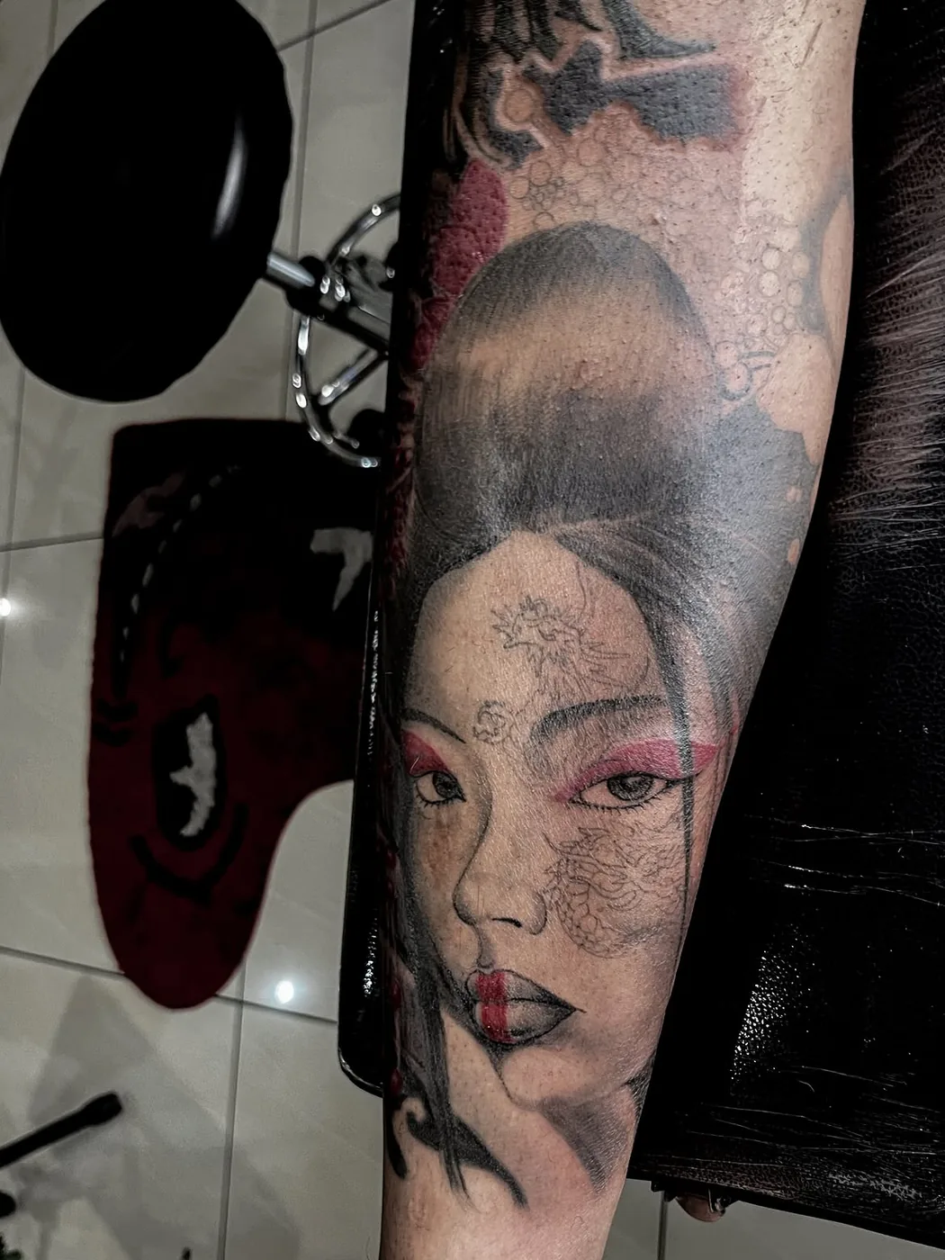 Portrait tattoo with red accent by Cash